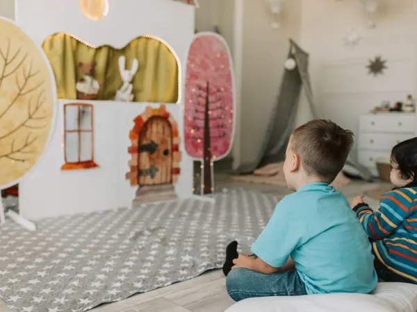 Children watching a puppet show in Dubai