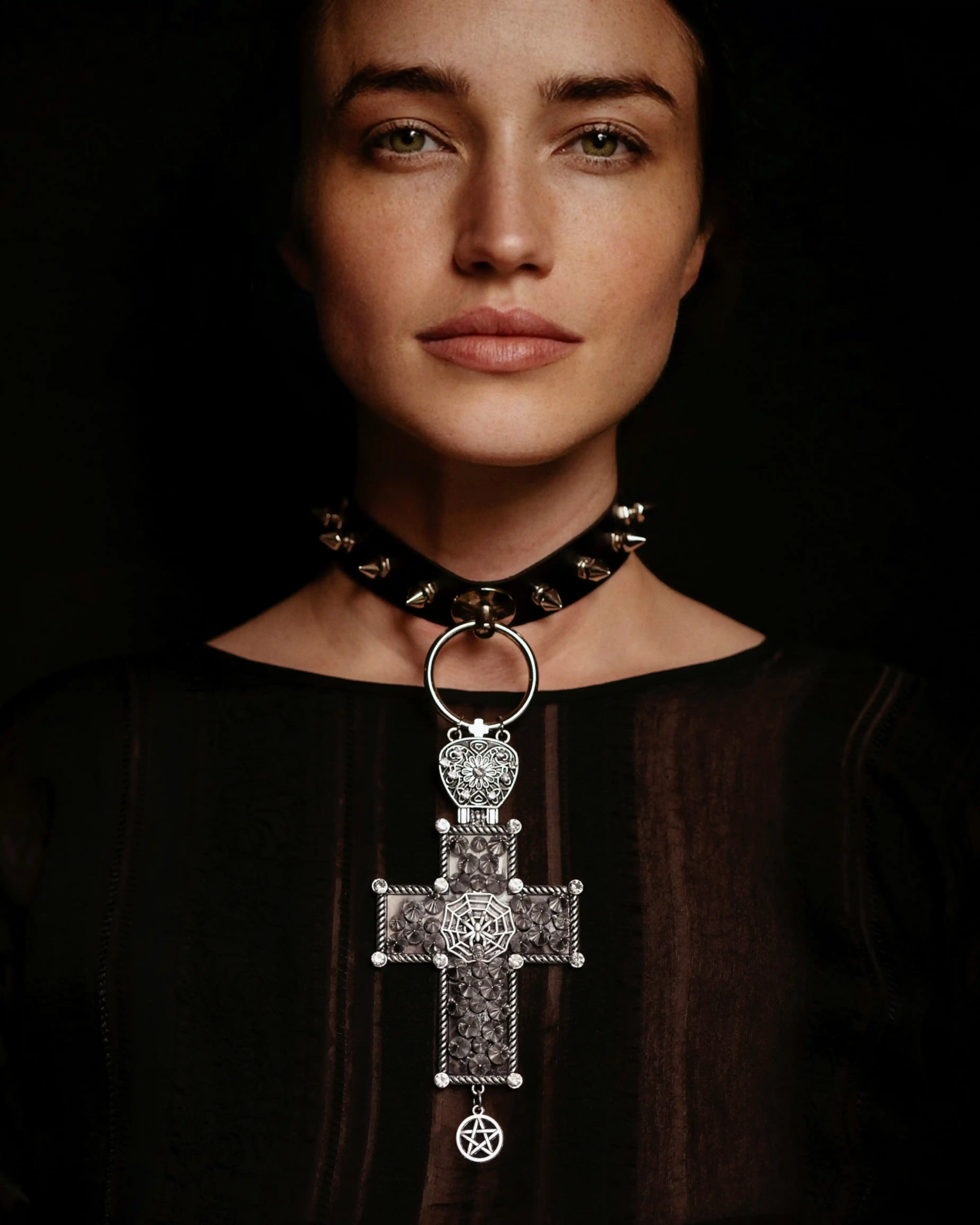 Gothic model in Dubai wearing spiked collar and ornate cross necklace for Coverpage talent showcase.
