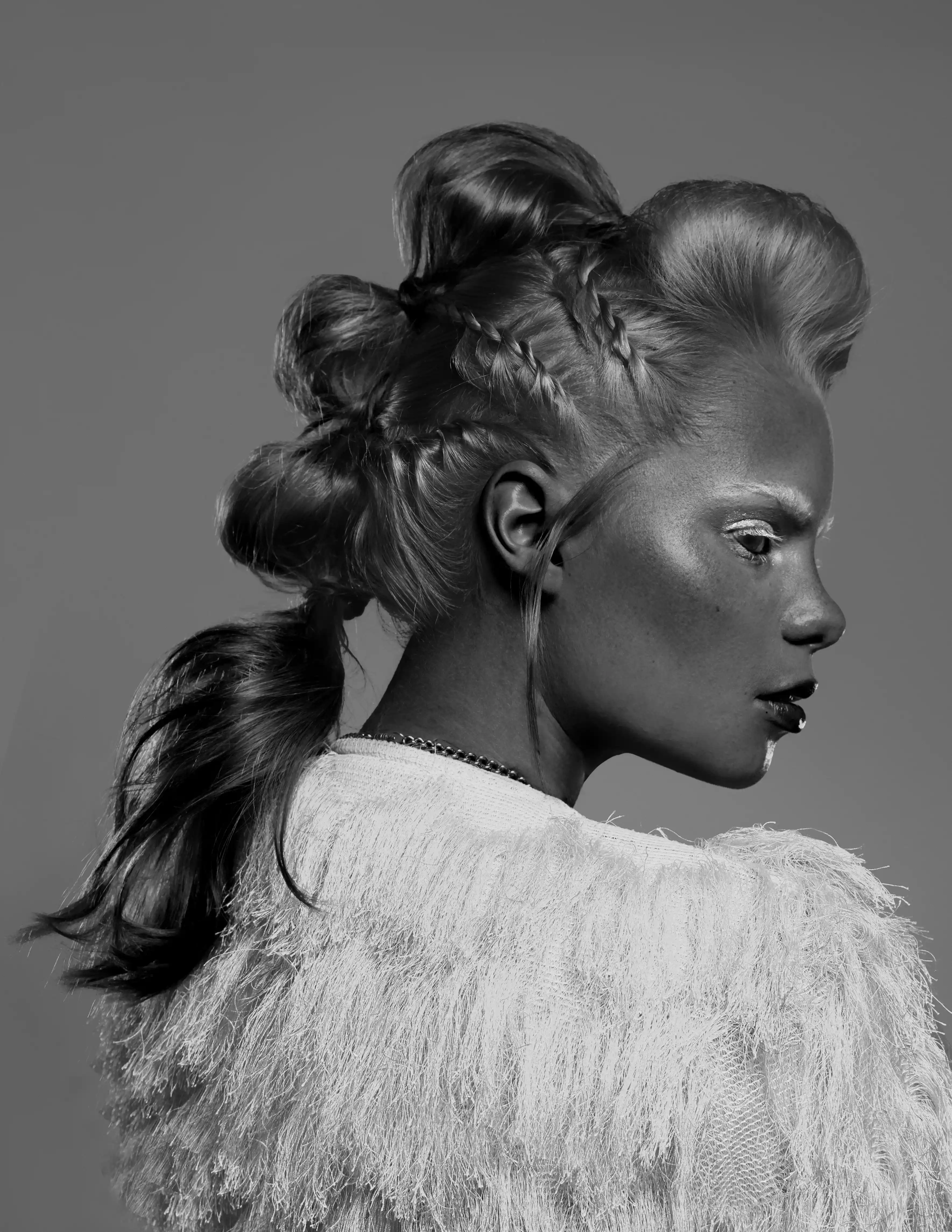 Intricate braided bun hairdresser model in fur top for luxury talent agency in Dubai, Coverpage.