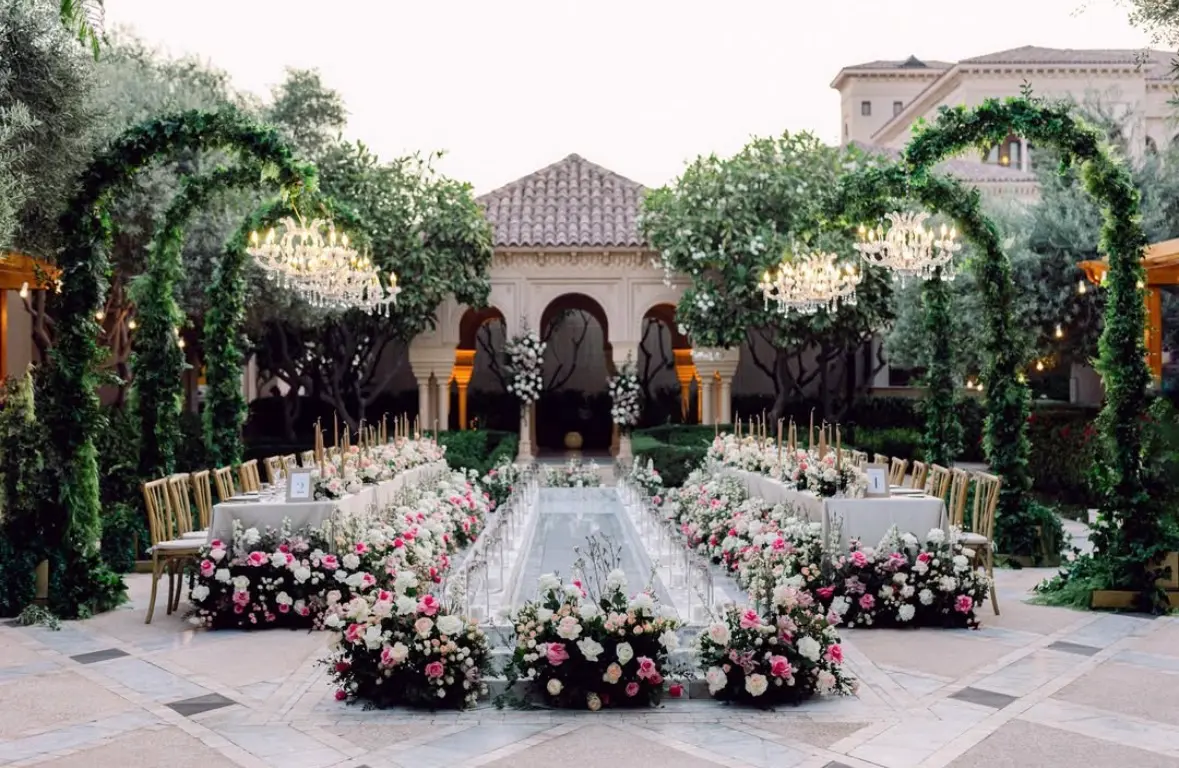 Cover Page Agency — luxury wedding outdoor reception photography floral arches chandelier Dubai 2026