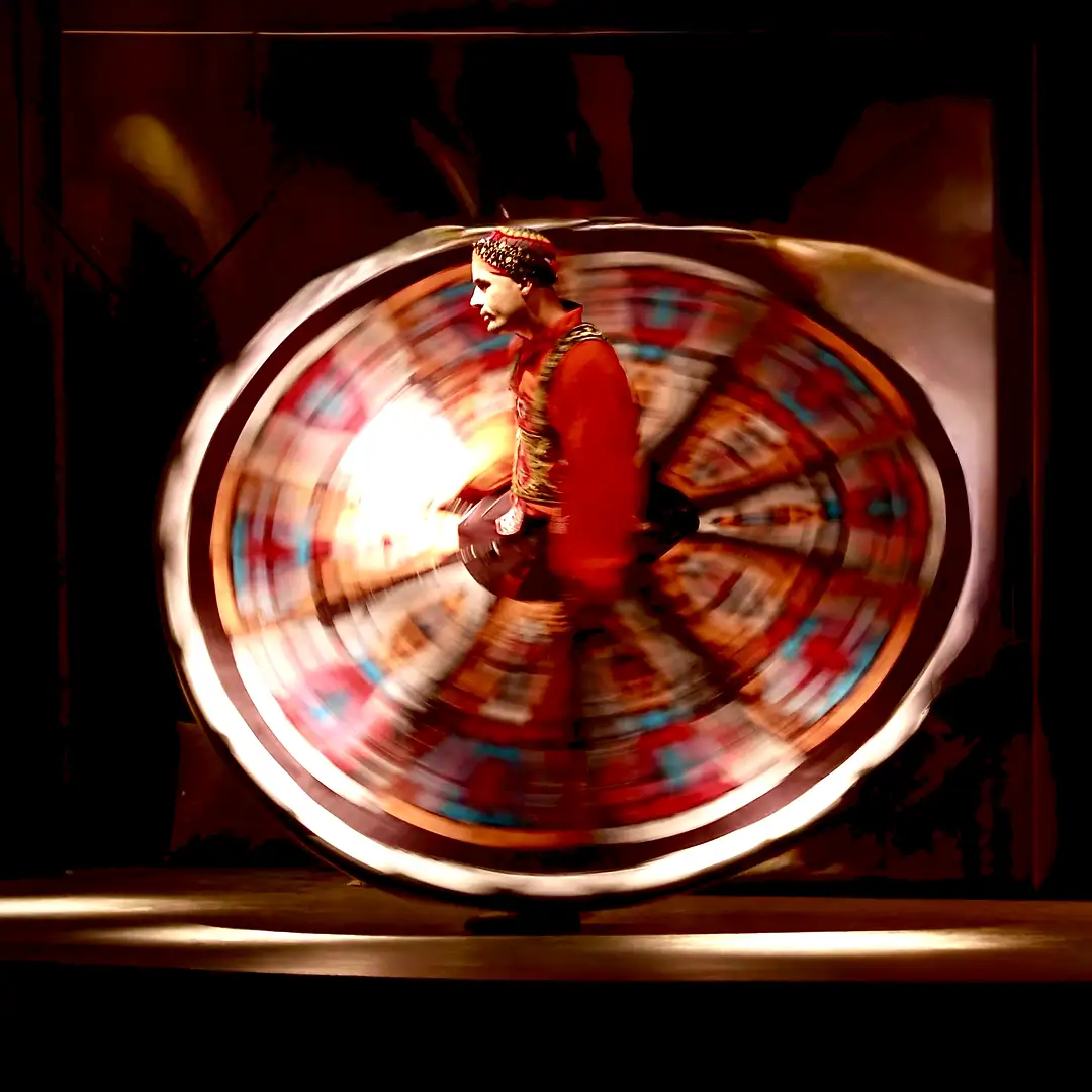 Mesmerizing luxury Tanoura dancer in vibrant red costume spinning at high speed, creating a stunning circular light trail for Cover Page Agency Dubai. High-end Egyptian Sufi-inspired entertainment talent delivering hypnotic, colorful and energetic whirling performances at exclusive events and luxury cultural shows across the UAE.