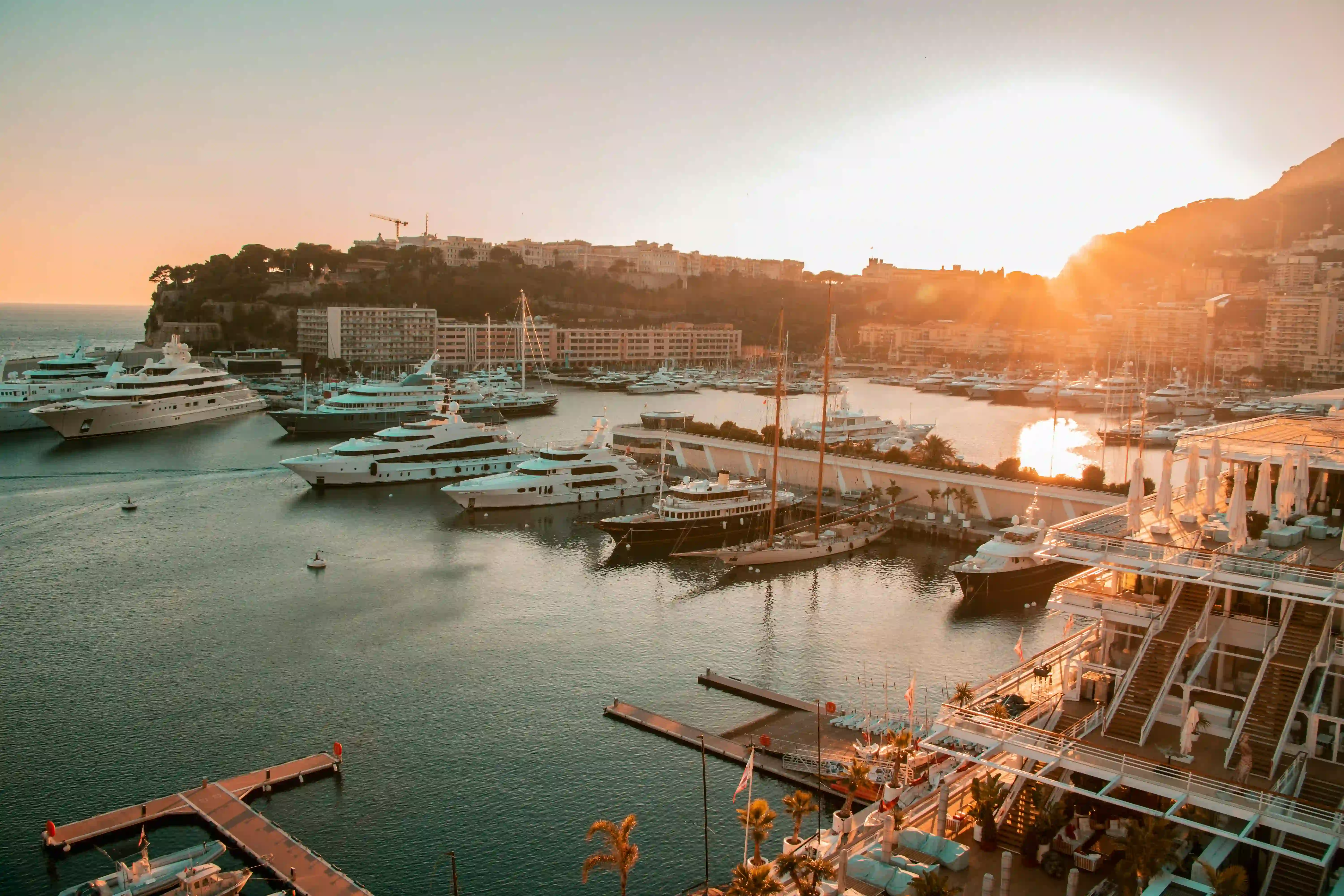Luxury brand activation setup at Monaco Grand Prix 2026 — branded pop-up with Port Hercule harbour in background