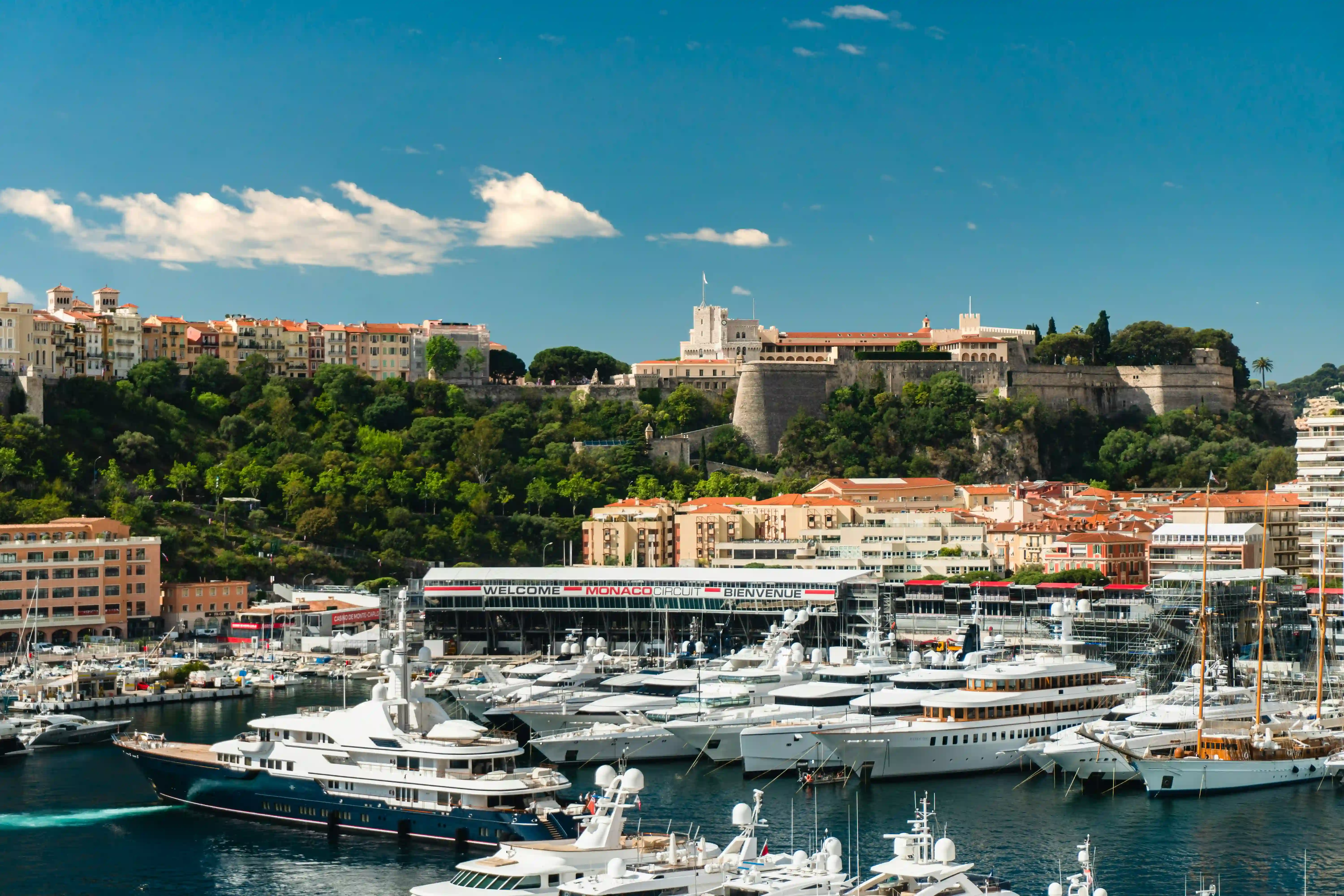 Drone aerial view of Port Hercule during Monaco Grand Prix week 2026 — superyachts, harbour and Circuit de Monaco from above
