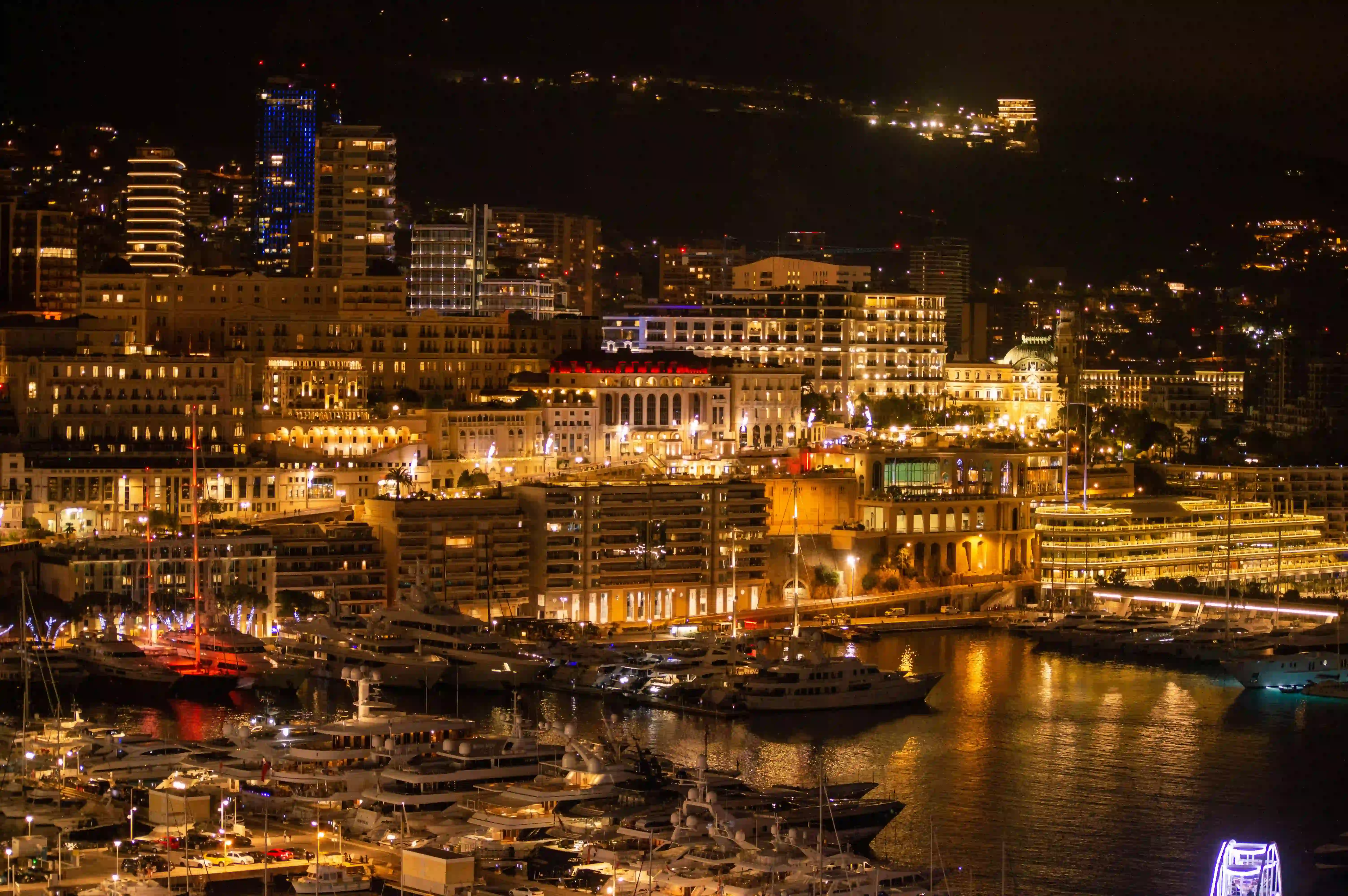 Yacht party during Monaco Grand Prix week in Port Hercule, with superyachts and the rock of Monaco in the background