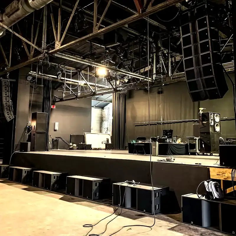 Stage with sound system and lighting rig set up for an event