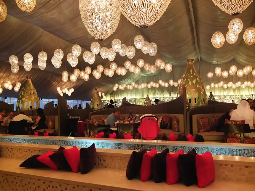 Ramadan iftar tent in Dubai with hanging lanterns and majlis seating