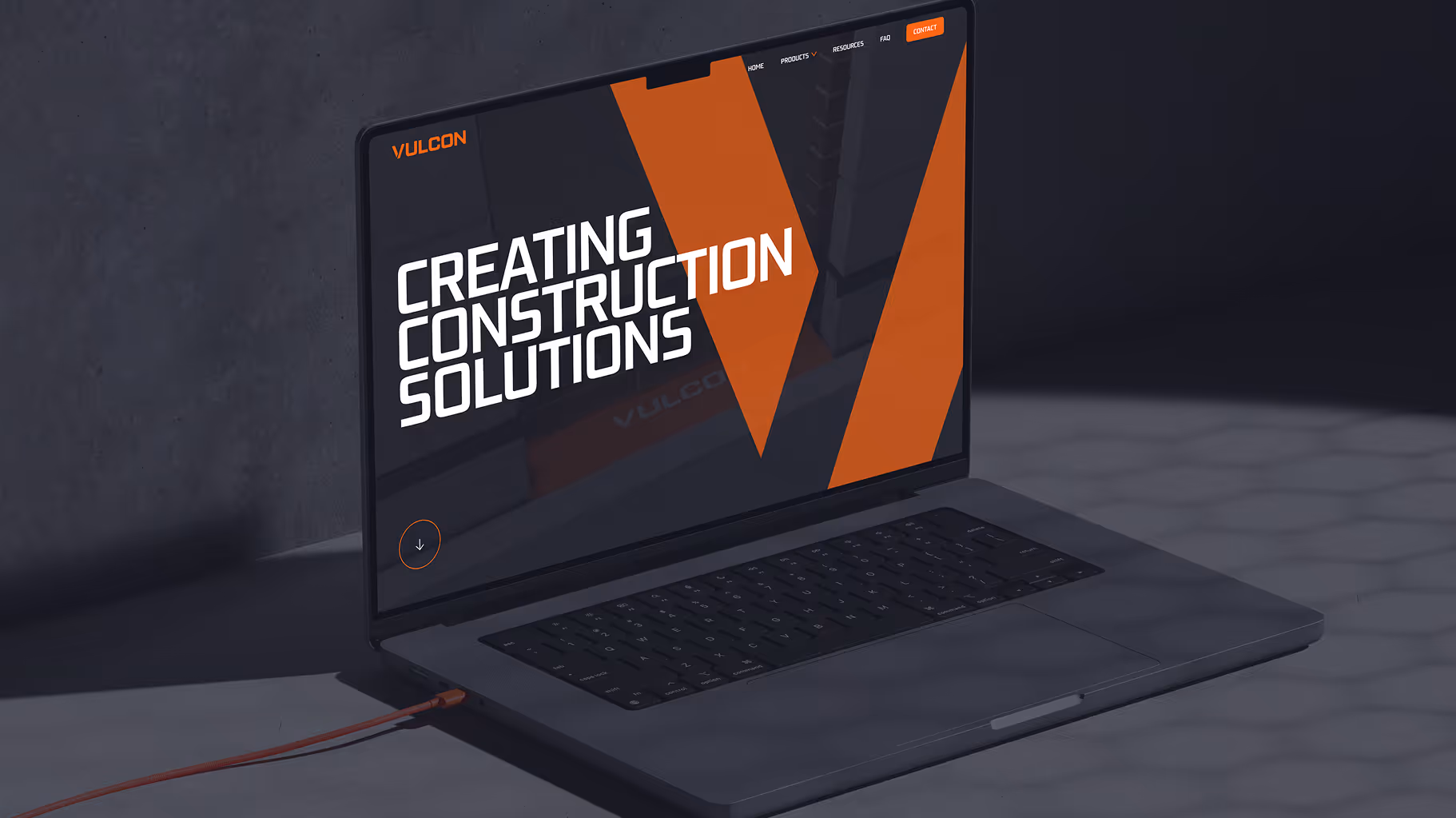 Laptop screen displaying 'CREATING CONSTRUCTION SOLUTIONS' with orange and black design elements.