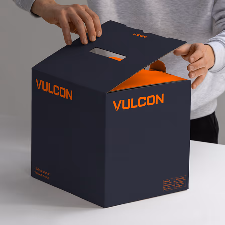 Two hands opening a black box with orange interior and the brand name VULCON on its sides.
