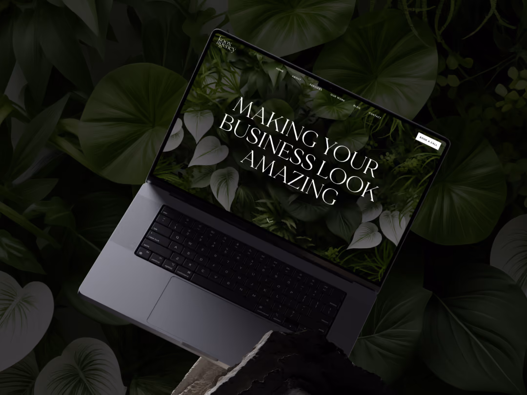 Laptop showing a website with leaves background and text 'Making your business look amazing.'