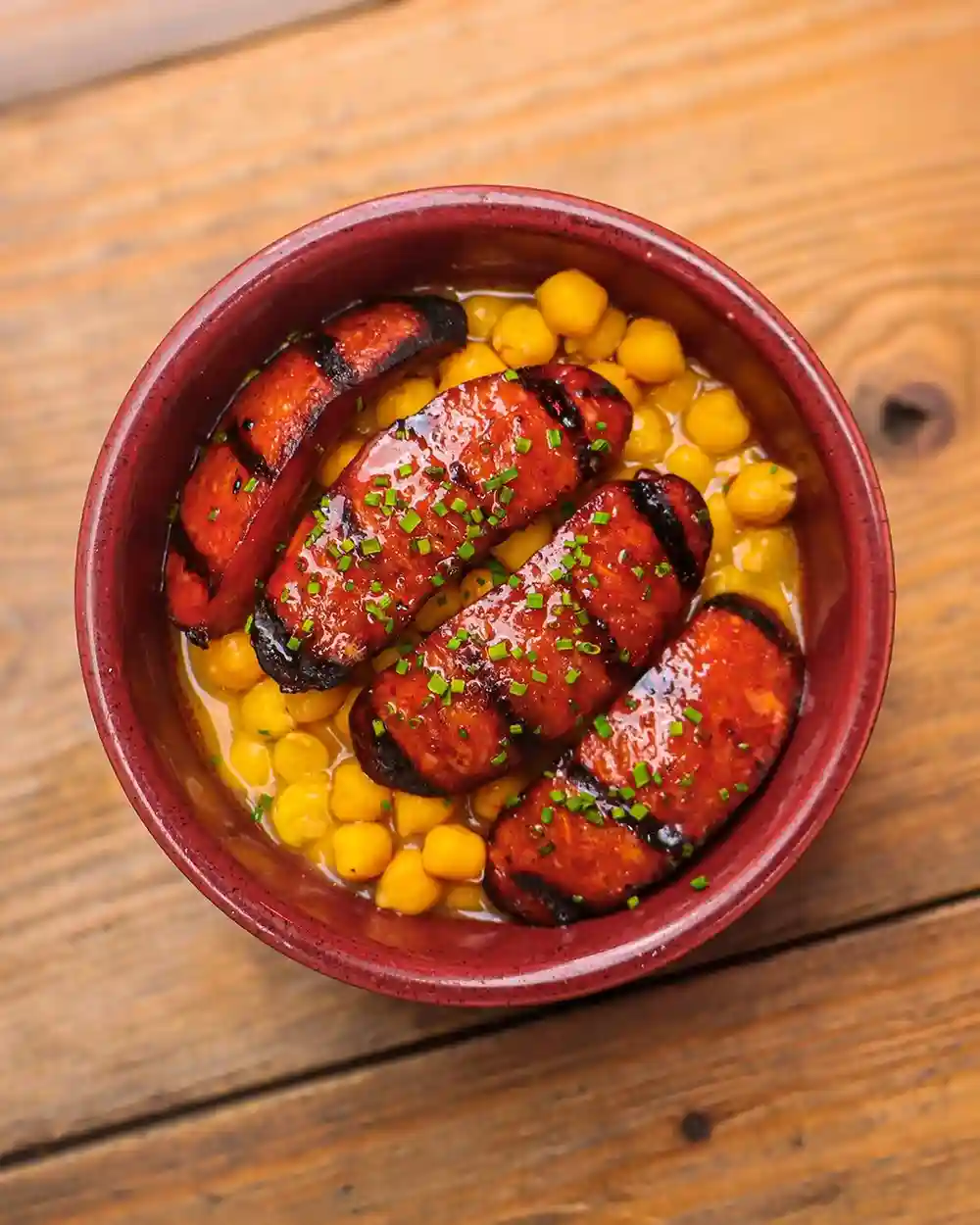 Moments after taking this photo, it started to tip down in Carnaby Street 🌧️ 

We didn't mind, though, as when we began to eat this dish, a feeling of cosiness swept over us all. These beautiful chargrilled chorizo picante served over a gorgeously wholesome chickpea stew pushed the rain right away 🌞 

Join us this week to banish those early autumnal blues.