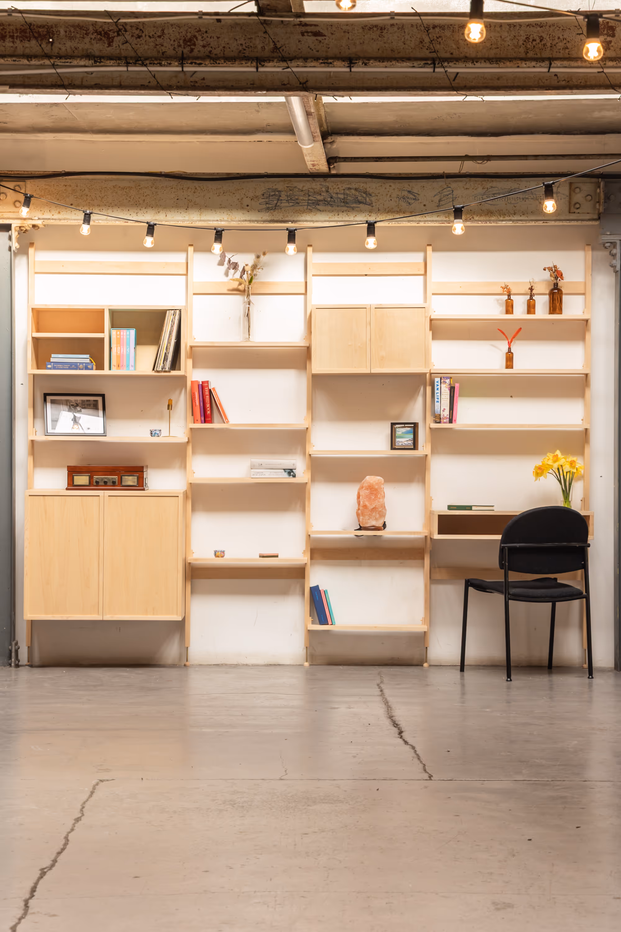 A large, four-bay Forma shelving unit by Bruntsfield Designs with shelves, cabinets and a desk.