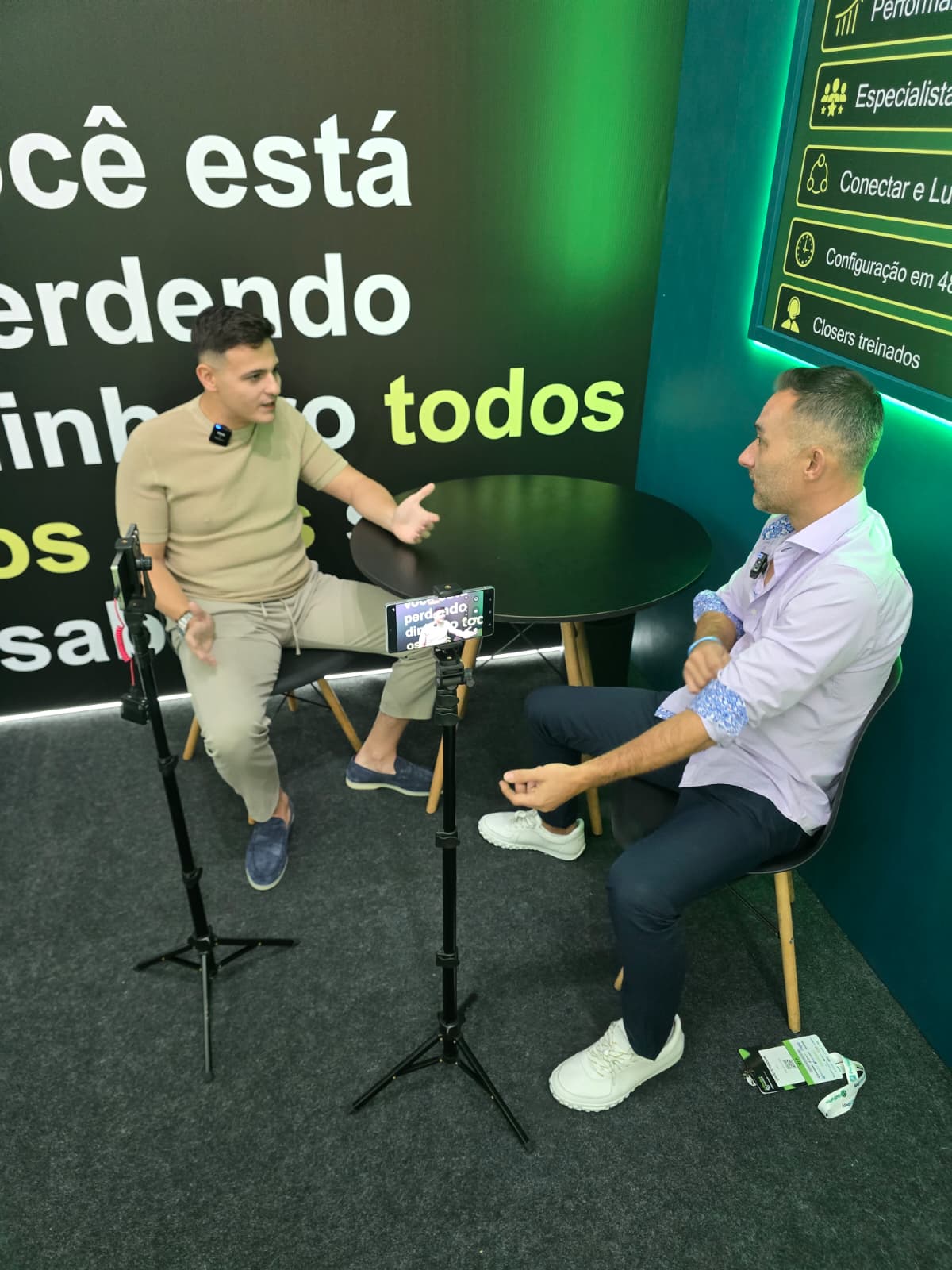 	Man in blue blazer being interviewed on camera in front of an iSellForYou stand