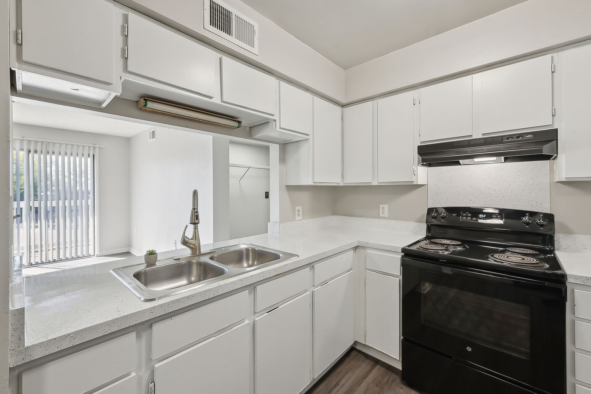 Kitchen with white cabinets and black appliances