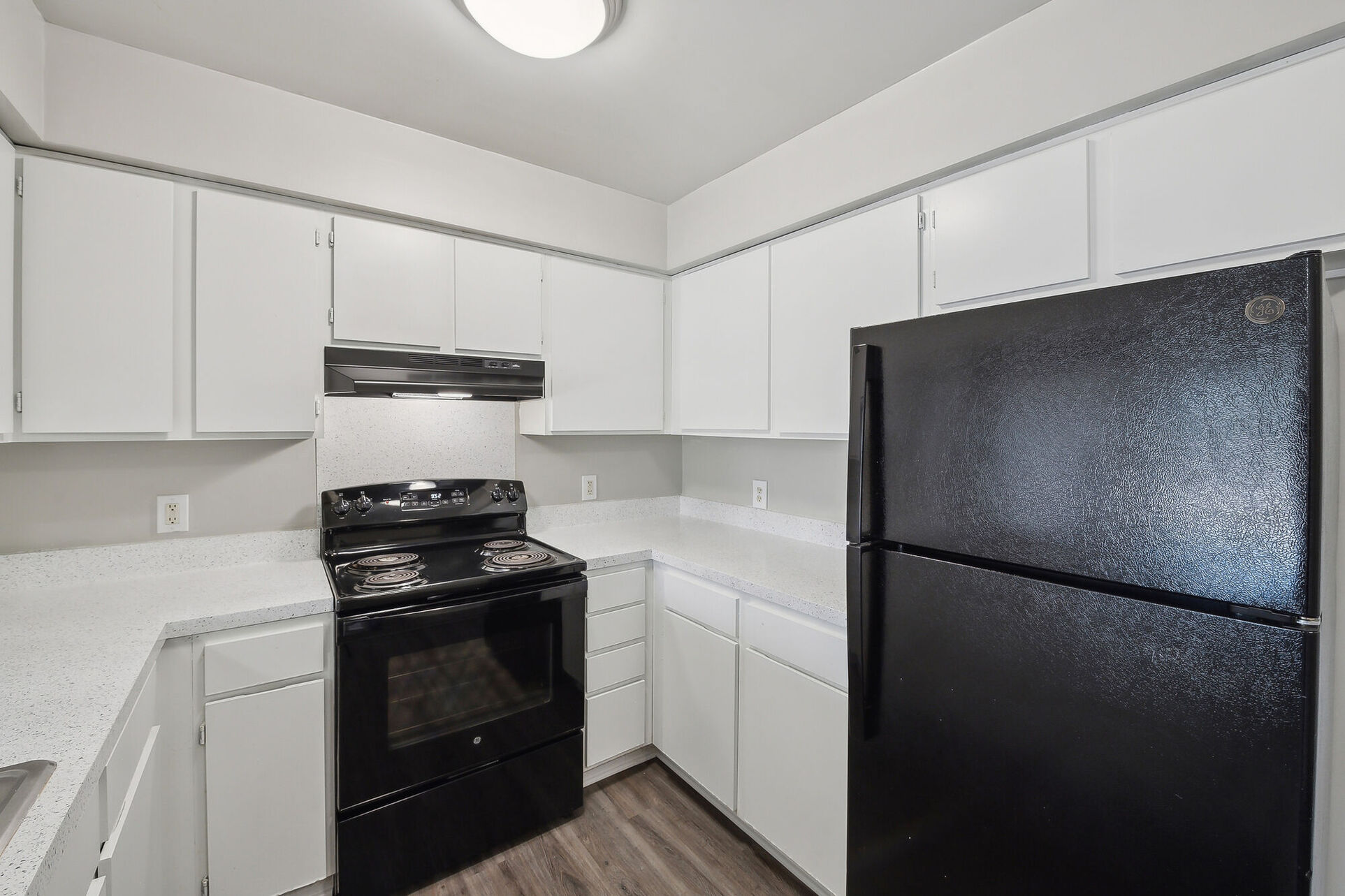 Kitchen with white cabinets and black appliances