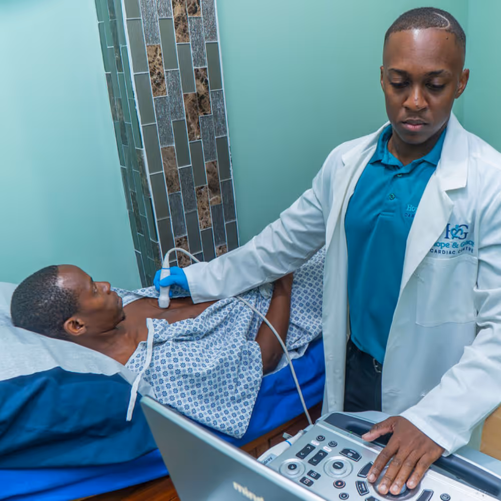 Medical professional performing an ultrasound on a patient lying on a bed in a clinical room.