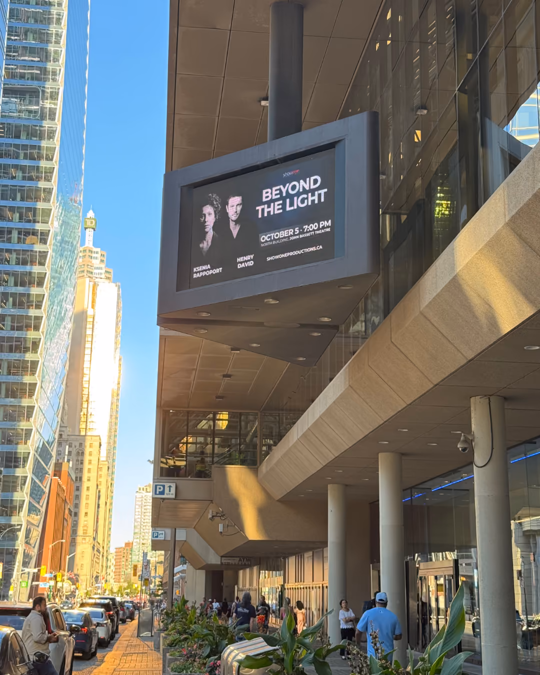 Outdoor digital billboard on a MTCC displaying an advertisement for 'Beyond The Light' featuring Ksenia Rappoport and Henry David, with event details
