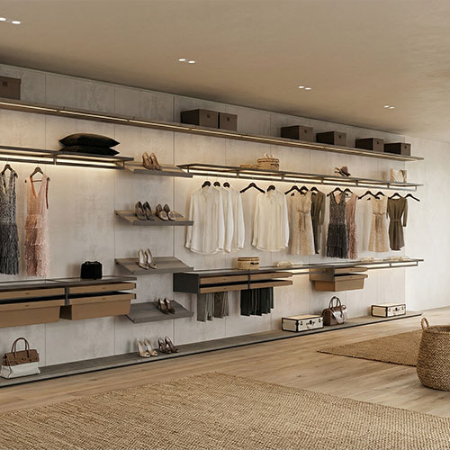 Luxury wall-mounted closet system with integrated LED lighting and wood wall panels in a Nantucket dressing suite.