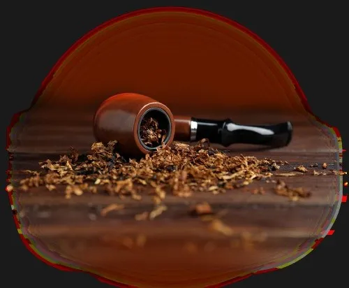 A pipe and a pile of wood shavings on a table.