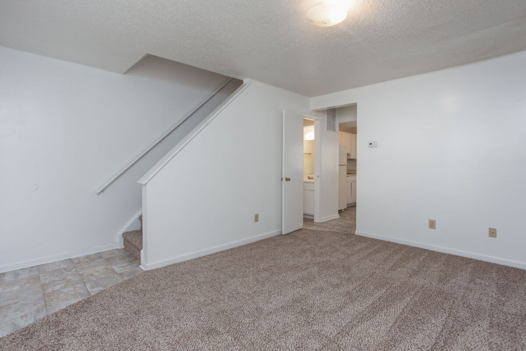 Living room with carpet and stairs