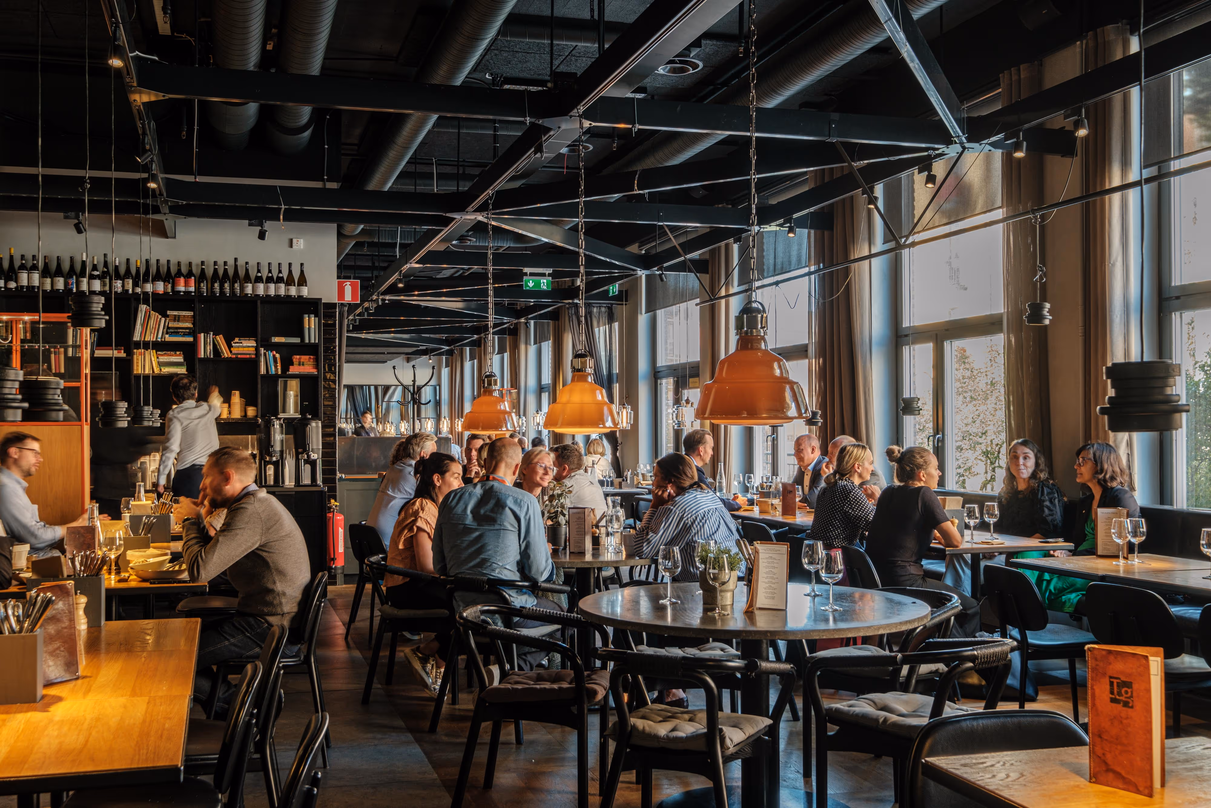 A group of people sitting at a table in a restaurant.