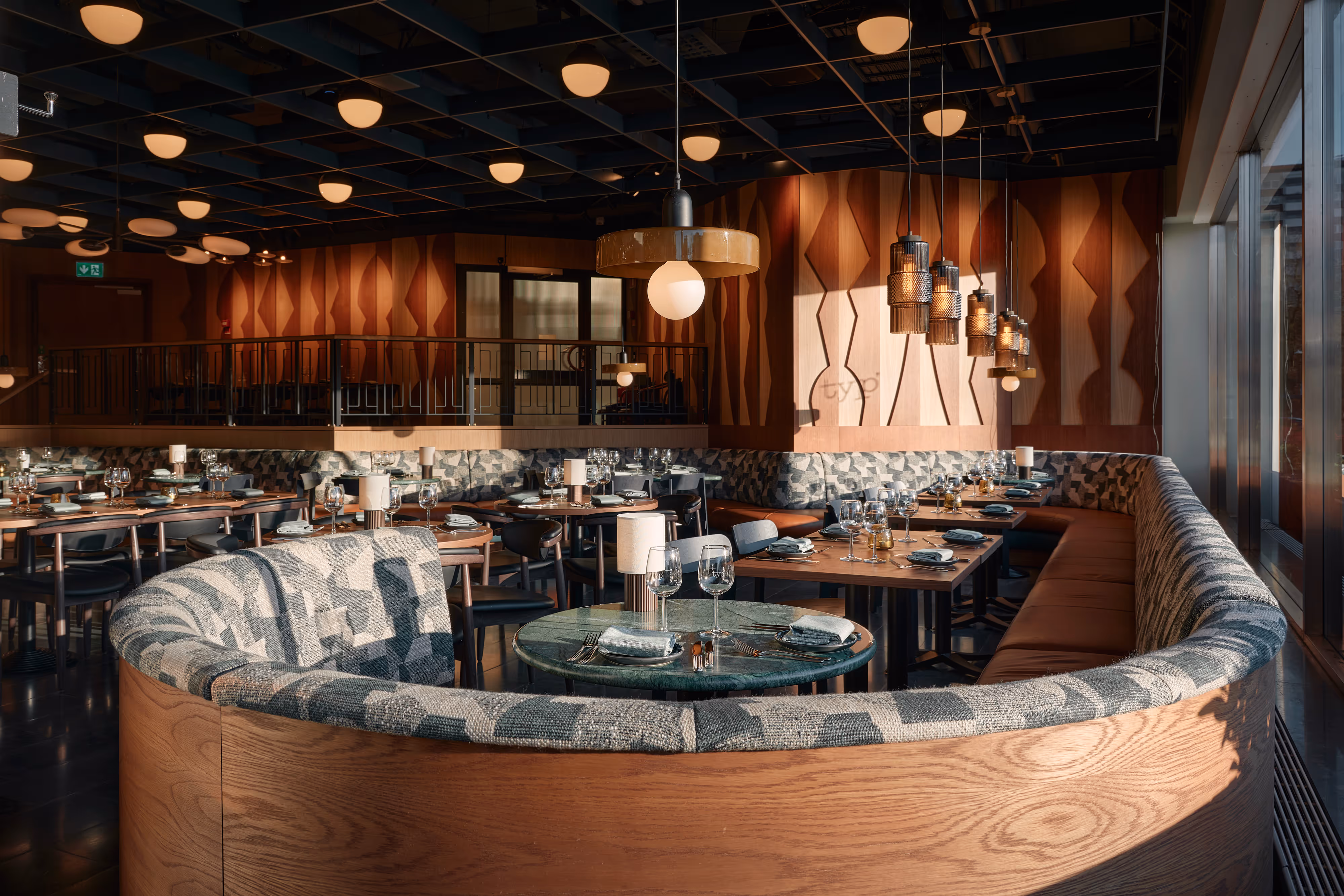 A restaurant with a wooden table and chairs.