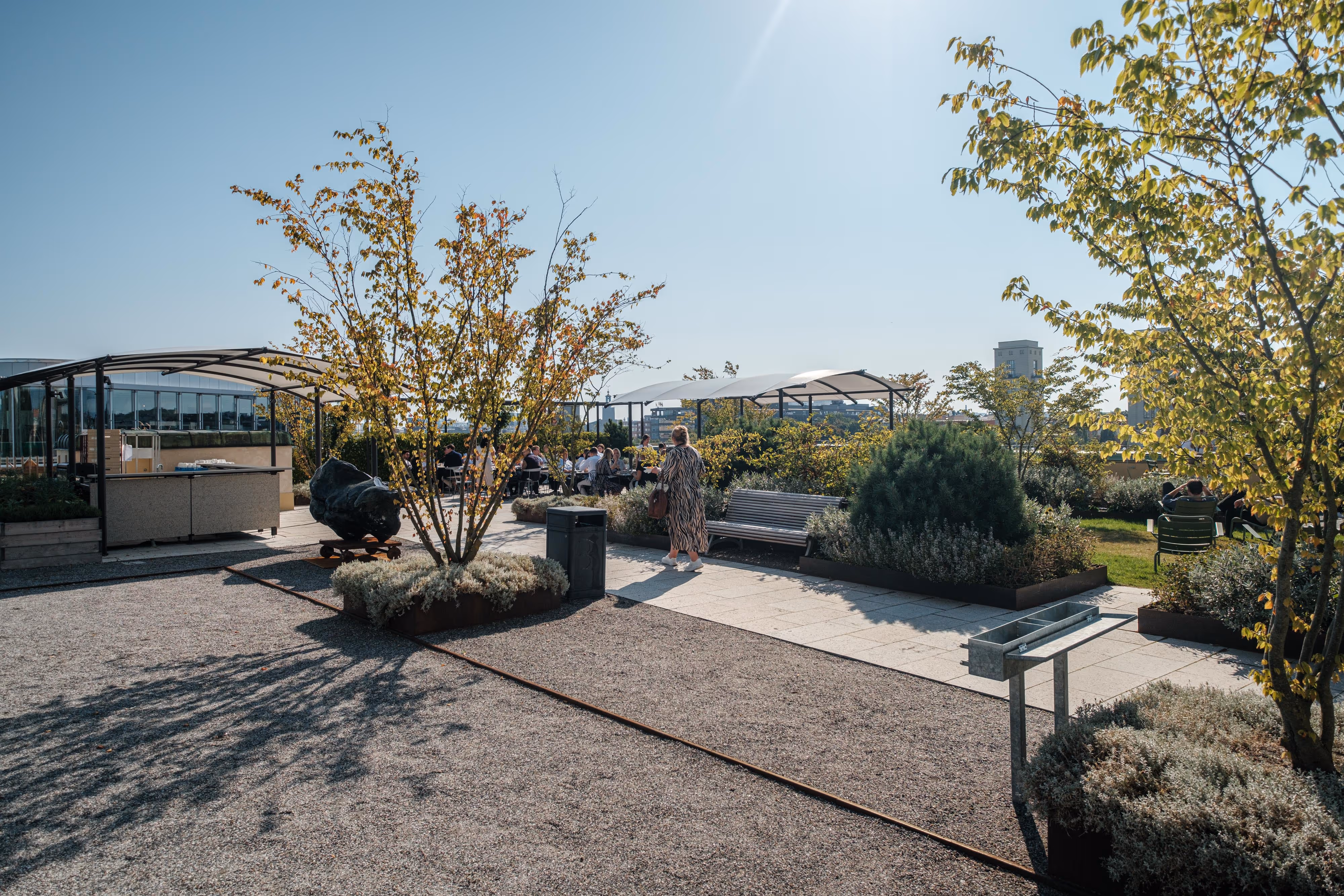 A woman walking on a sidewalk in front of a building.