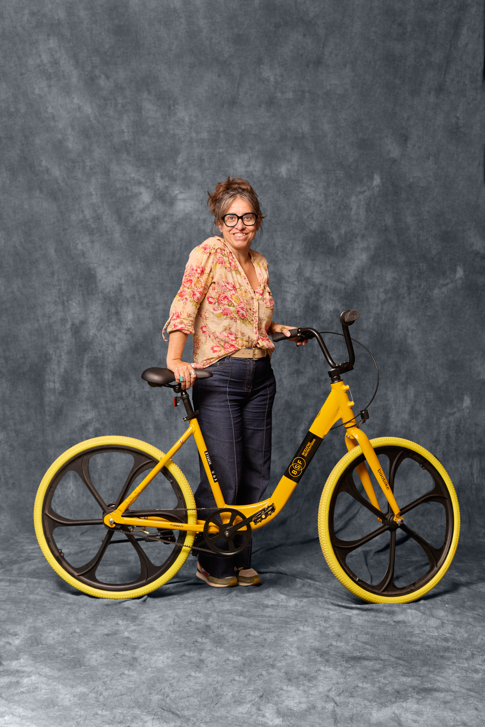 Portrait of cyclist with Baobike bicycle against studio background