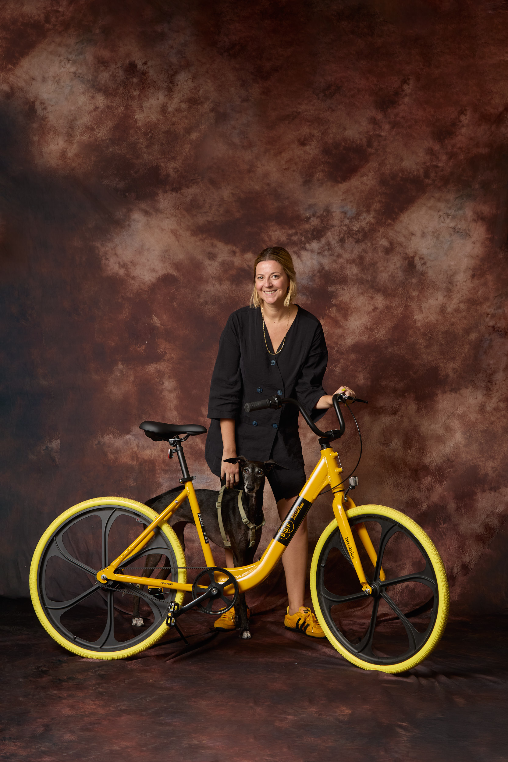 Cyclists Without Borders Baobike rider portrait with yellow bicycle and studio backdrop