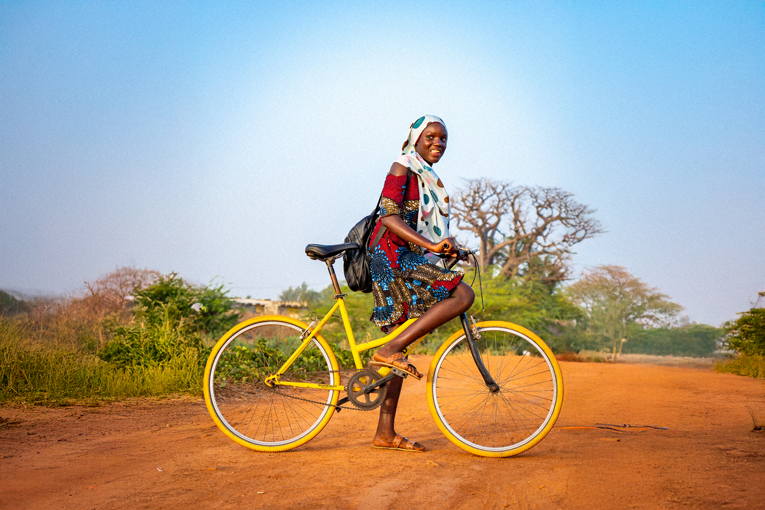 Cyclists Without Borders Baobike rider with yellow bicycle on dirt road in Senegal