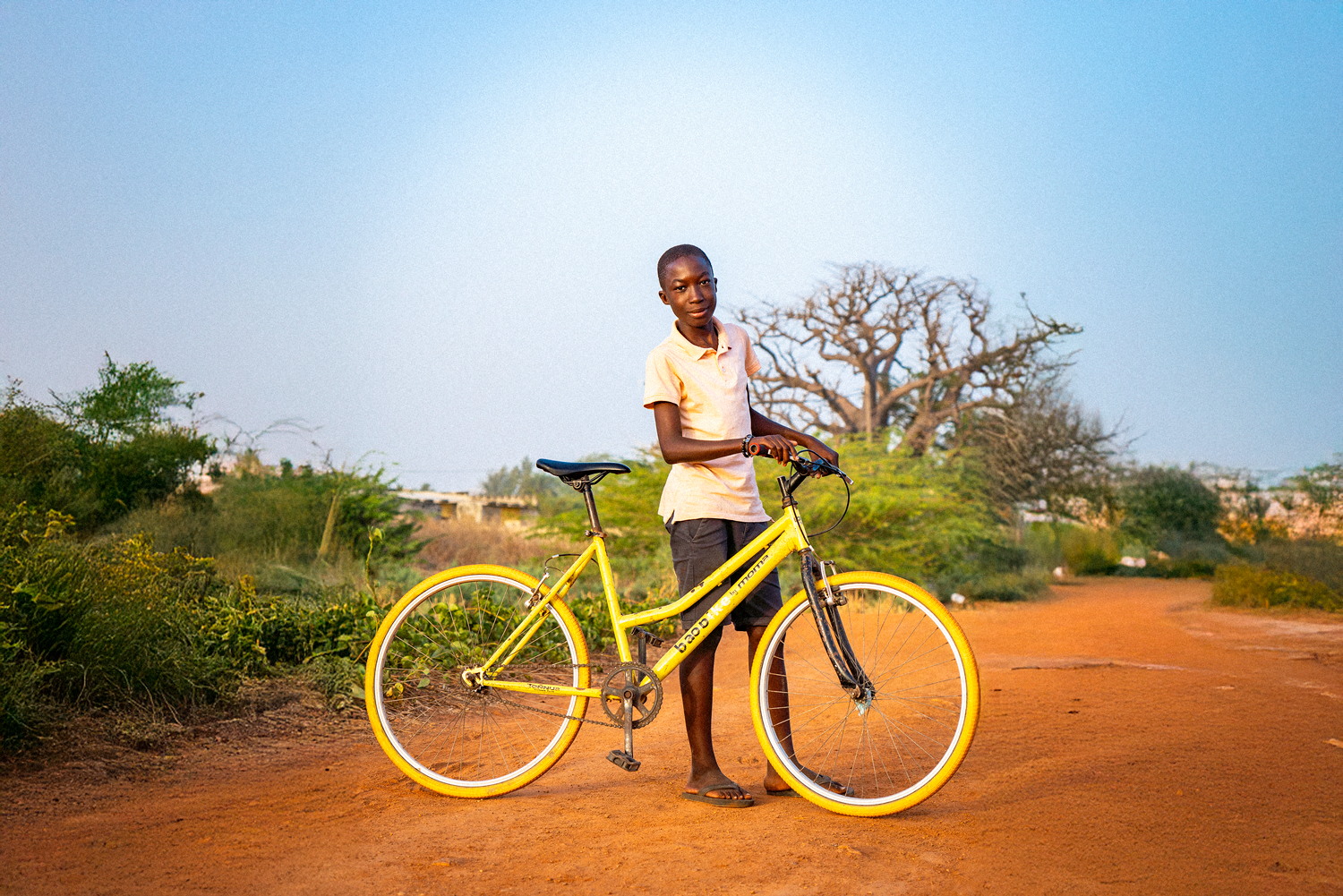 Student with Baobike bicycle on rural road in Senegal