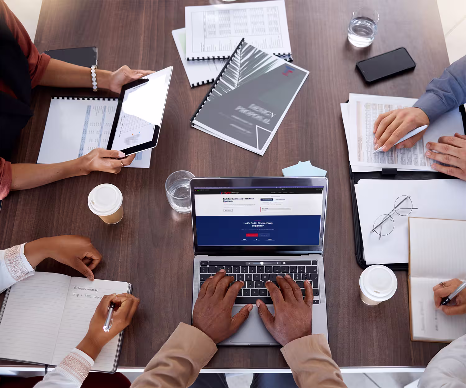 Business consultants collaborating during a strategic planning meeting around a modern conference table.
