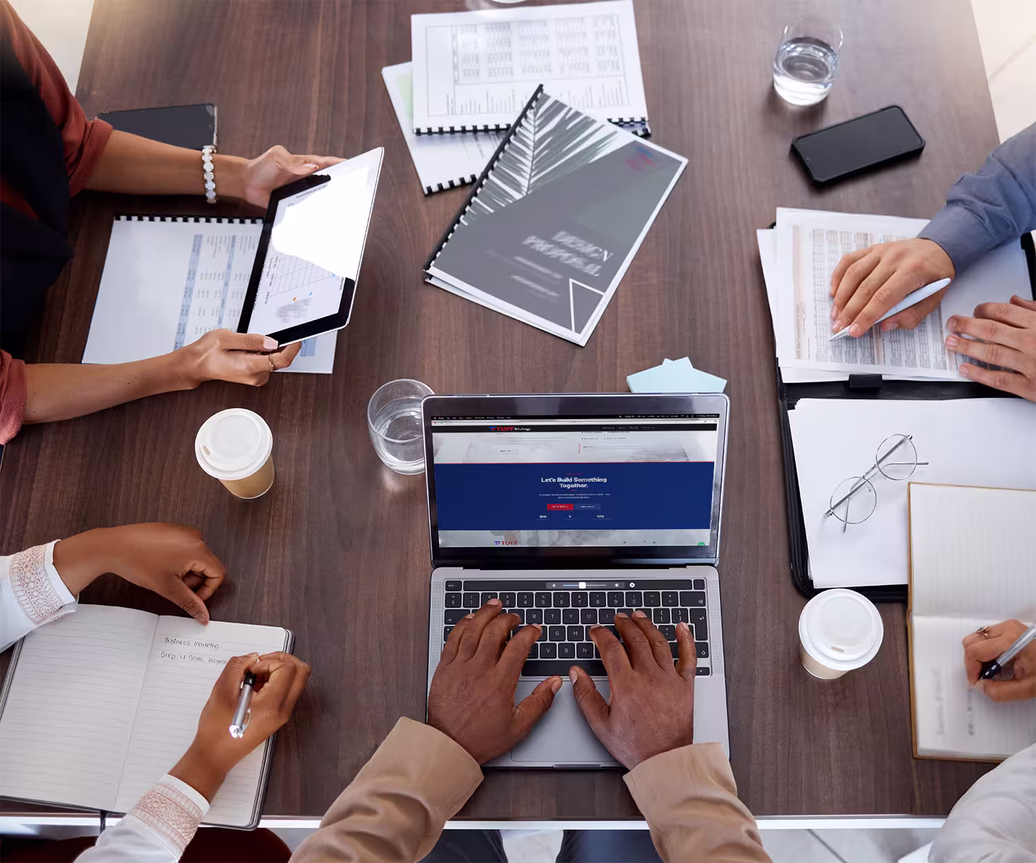 Business consultants collaborating during a strategic planning meeting around a modern conference table.