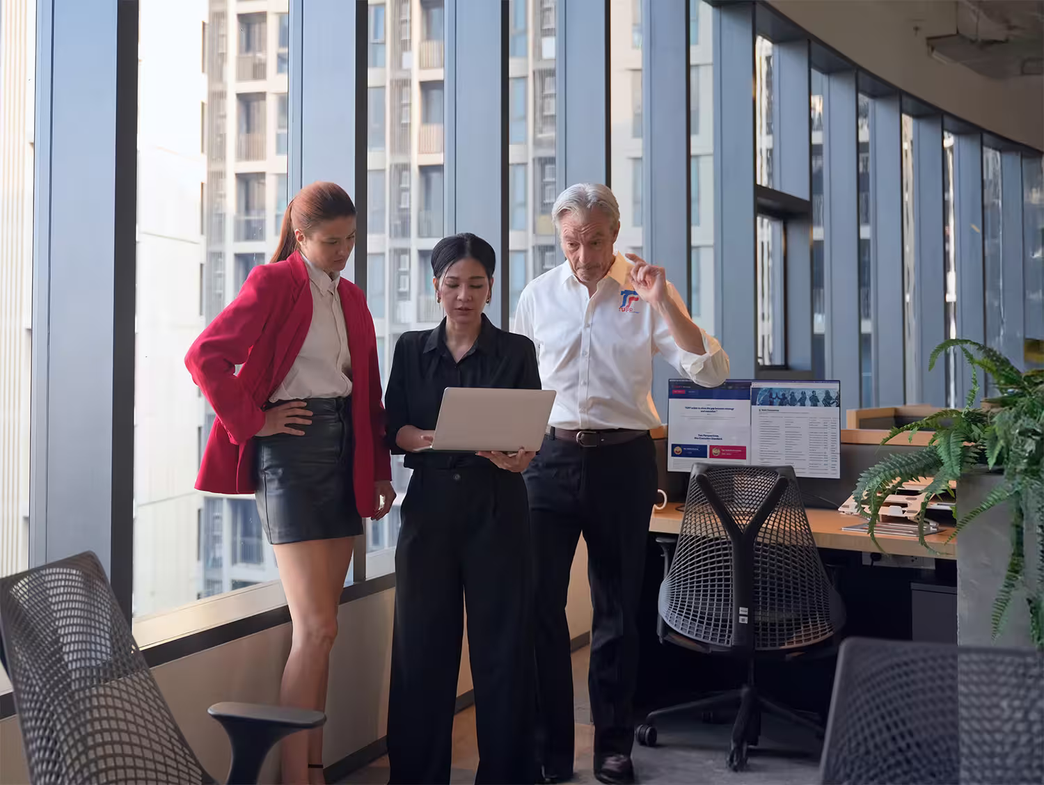 Business consultants collaborating in a modern UAE office environment during a client planning discussion.