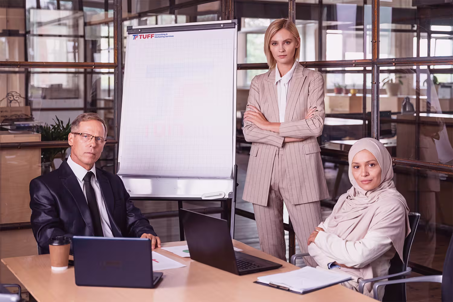 TUFF Strategy consultants collaborating during a business planning discussion inside a modern executive office.