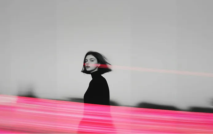 Grayscale photo of a woman with a large pink streak across it