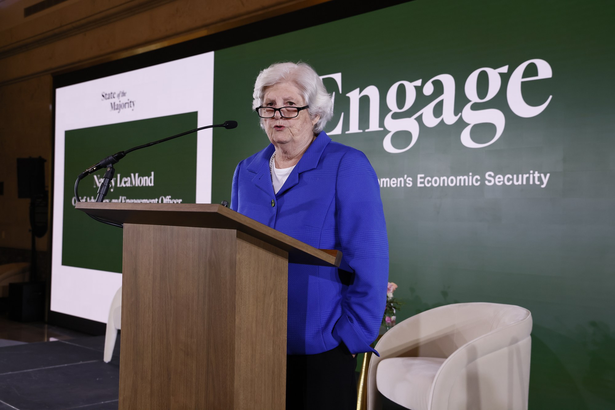 Nancy LeaMond speaking at a podium at the Engage Summit