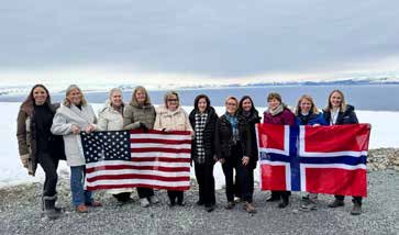 Bipartisan women senators holding U.S. and Norwegian flags during an Arctic congressional delegation trip