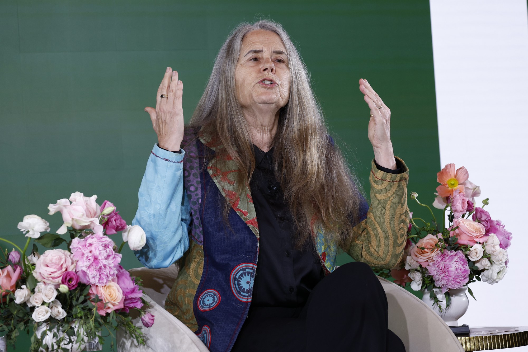 Dr. Lynn Shaw gesturing while speaking on stage