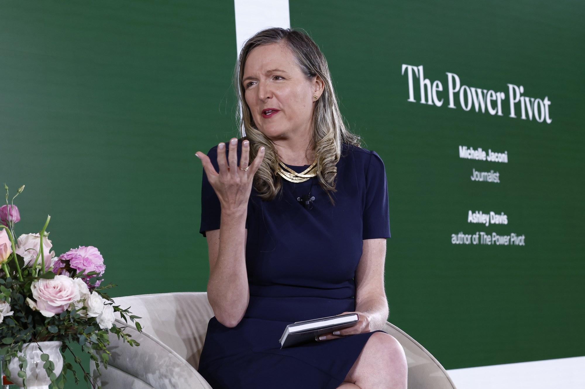 Speaker seated on stage during the fireside conversation at the Engage Summit