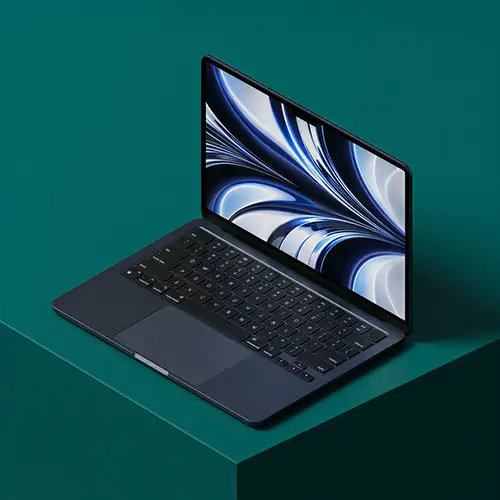 Modern laptop with black keyboard and abstract blue and white wallpaper on screen placed on a dark green surface.