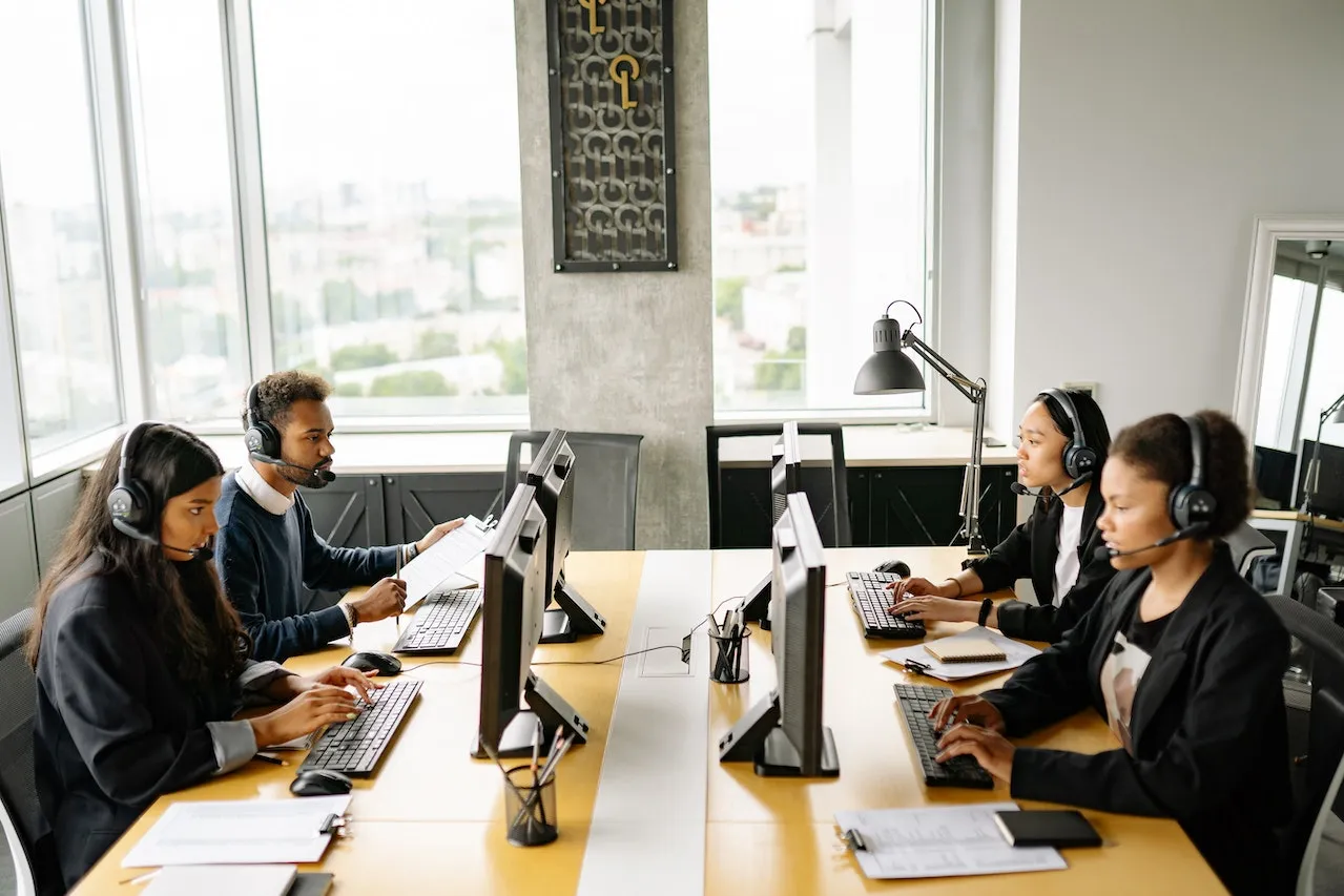 A group of customer service reps working in an office