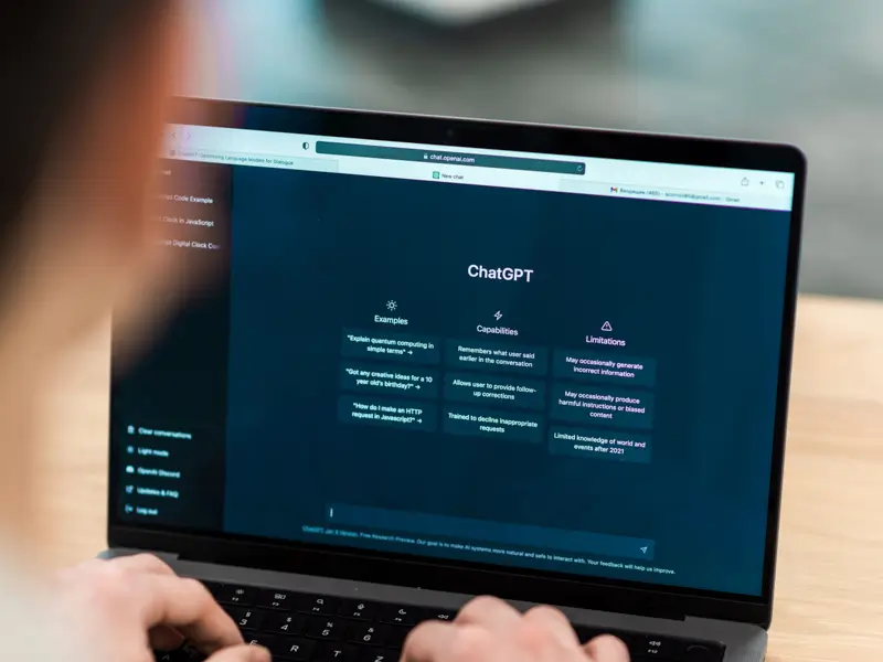 Professional using ChatGPT AI platform on laptop for recruitment screening and candidate evaluation processes