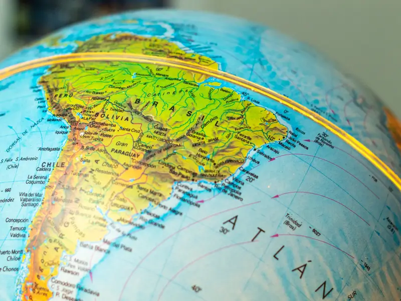 Close-up of a globe showing South America with country labels including Brazil, Bolivia, Chile, and the Atlantic Ocean