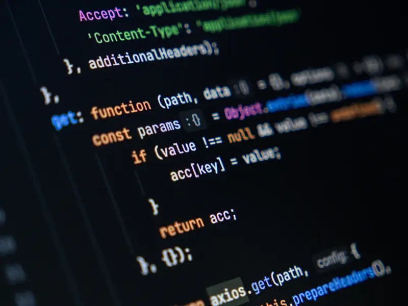 Close-up of a dark-themed code editor screen displaying JavaScript or PHP code with syntax highlighting in pink, orange, and white, showing function definitions, object parameters, and HTTP header configurations, representing backend web development work.