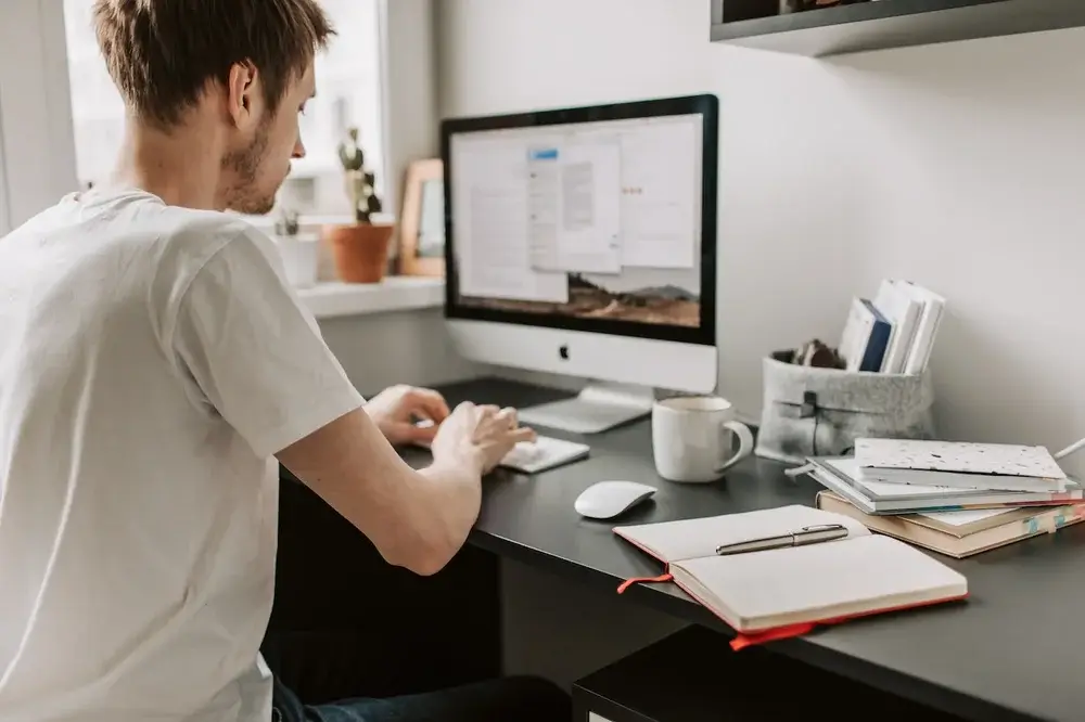 A young man working on his computer