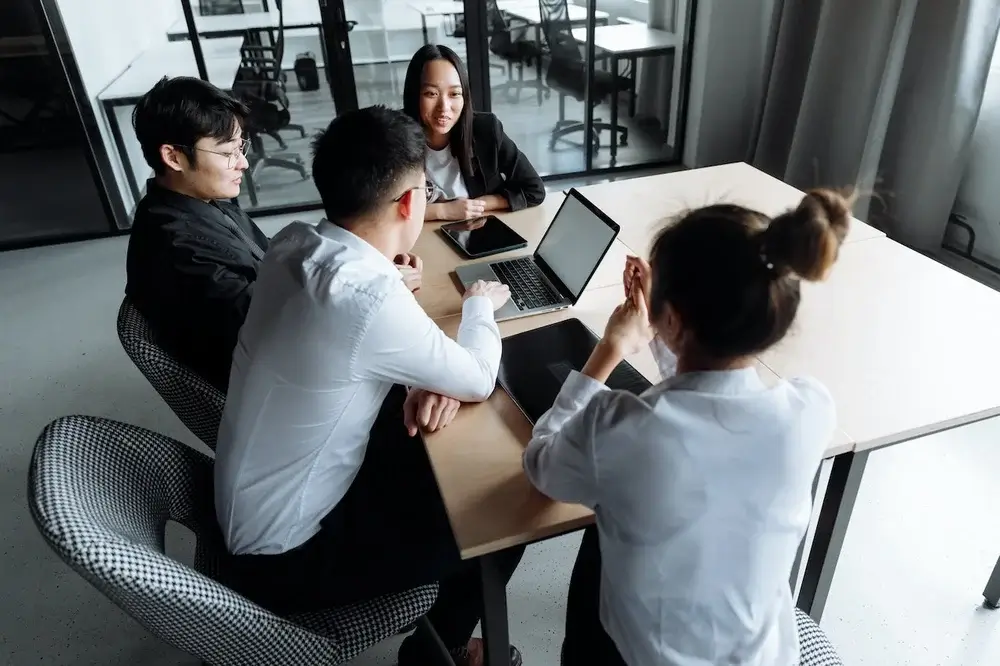 A team of four working together in a conference room