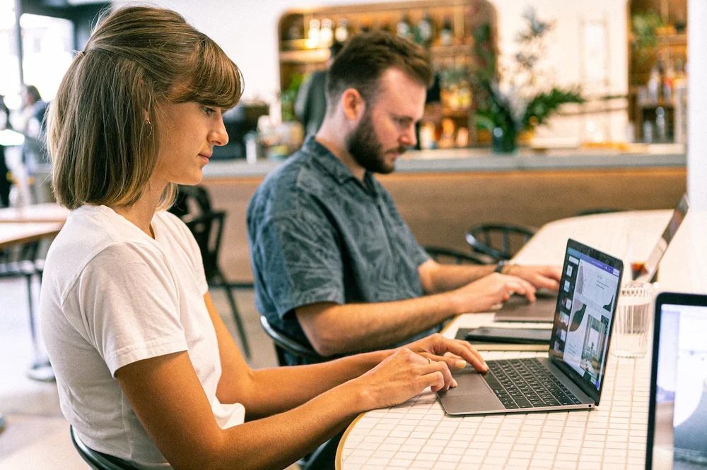 Two young people working in a coffee shop
