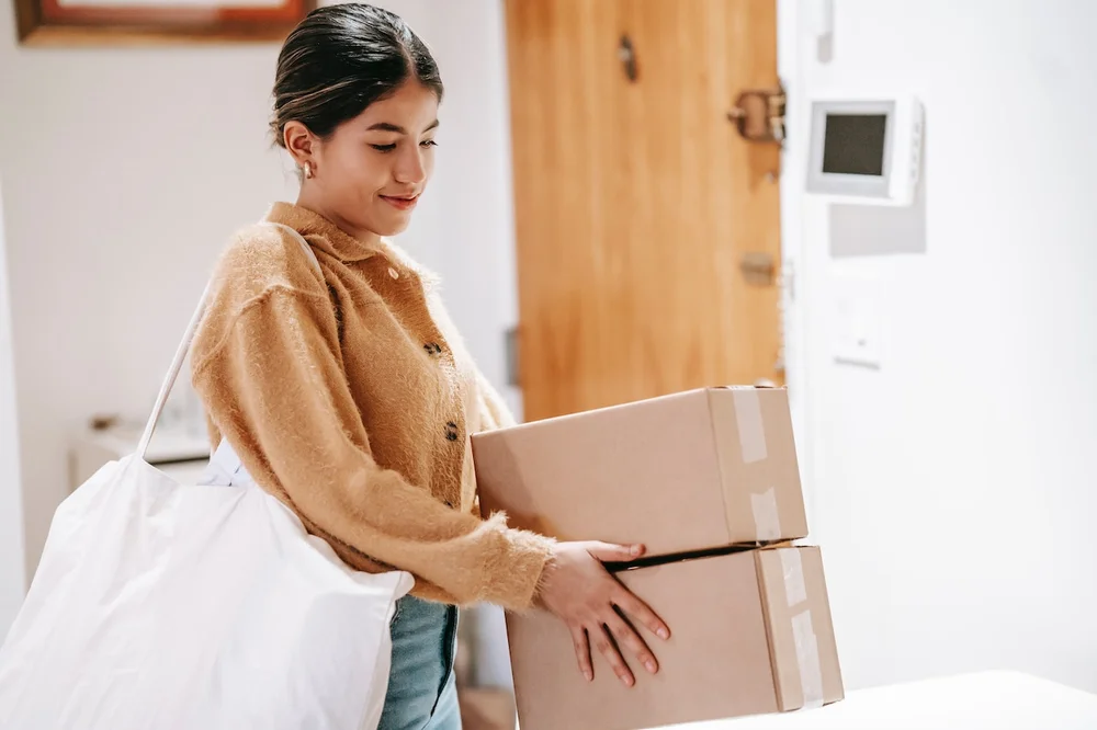 A young woman carrying packages