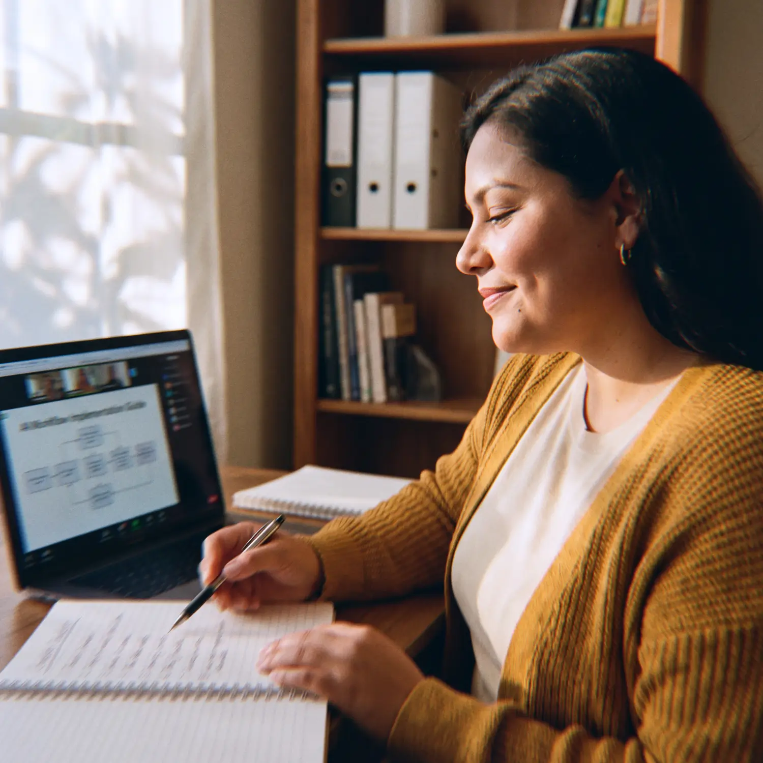 AI Implementation Specialist leading a screen-share training session from a notebook checklist in golden afternoon light