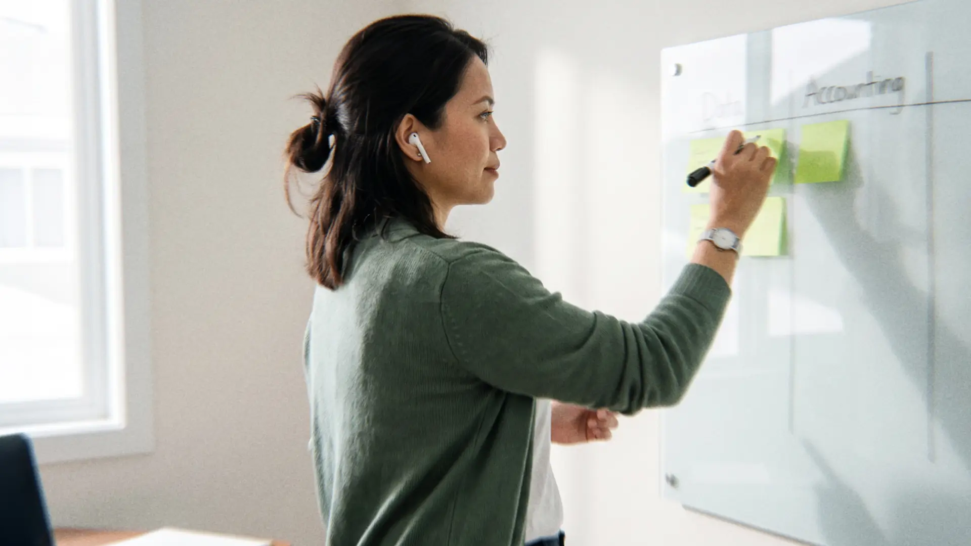 Offshore professional organizing accounting and operations workflows on a whiteboard for a law firm offshore staffing team